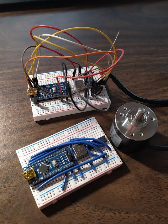 LS7366R IC's wired on breadboards with Arduino nanos, crystal oscillators, and an encoder.